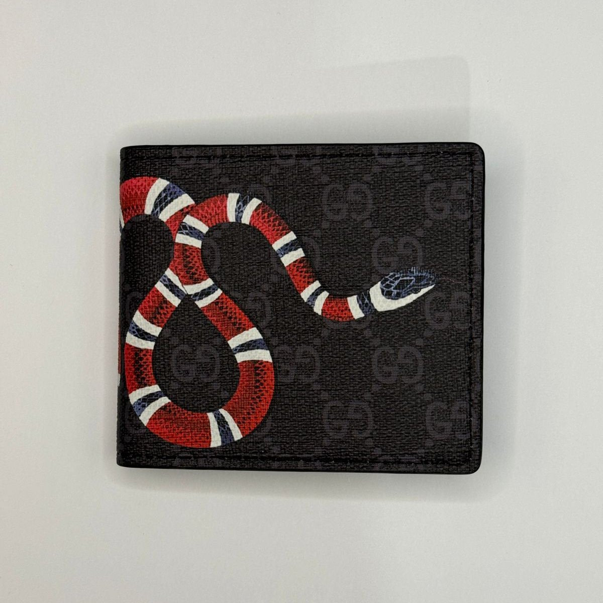 CARTERA GCCI NEGRA ESTAMPADO DE SERPIENTE